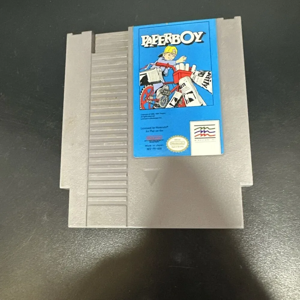 NES PAPERBOY TOY VIDEO GAME AND  SUPER MARIO BROS CARTRIDGE.